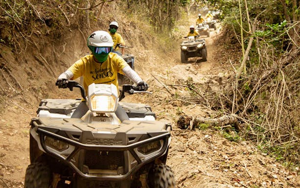 ATV riders navigating a forest trail in Puerto Vallarta.