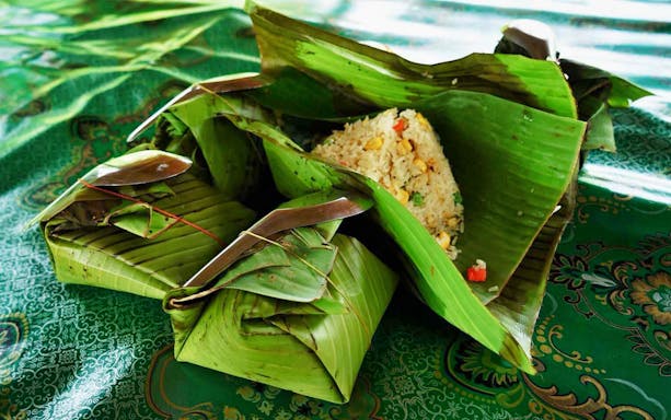 Banana leaf-wrapped rice dish served at Ker Chor Elephant Eco Park tour.
