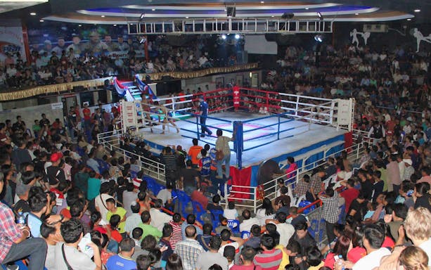 Crowd watching a boxing match at Chiang Mai Boxing Stadium.