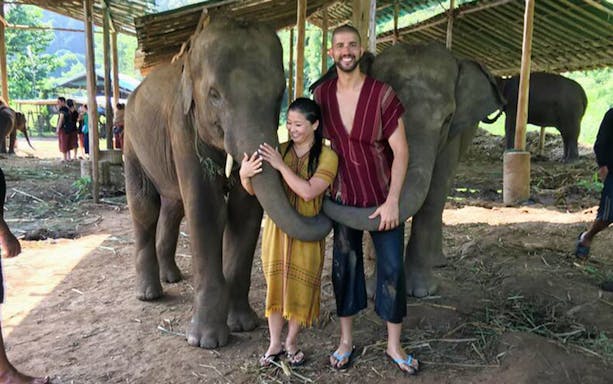 Visitors interacting with elephants at Ran Tong Elephant Care, Thailand.