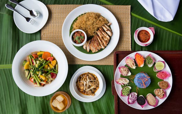 Traditional Thai dishes served on banana leaves at Araksa Tea Garden Tour.