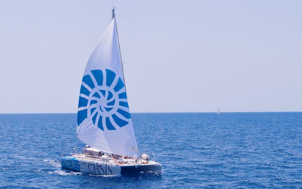 Catamaran sailing on open sea during a tour with lunch.