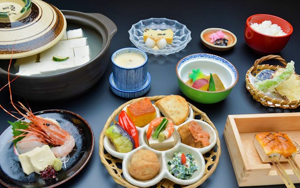 Traditional Japanese meal with tofu, tempura, and seafood on Kyoto sightseeing tour.
