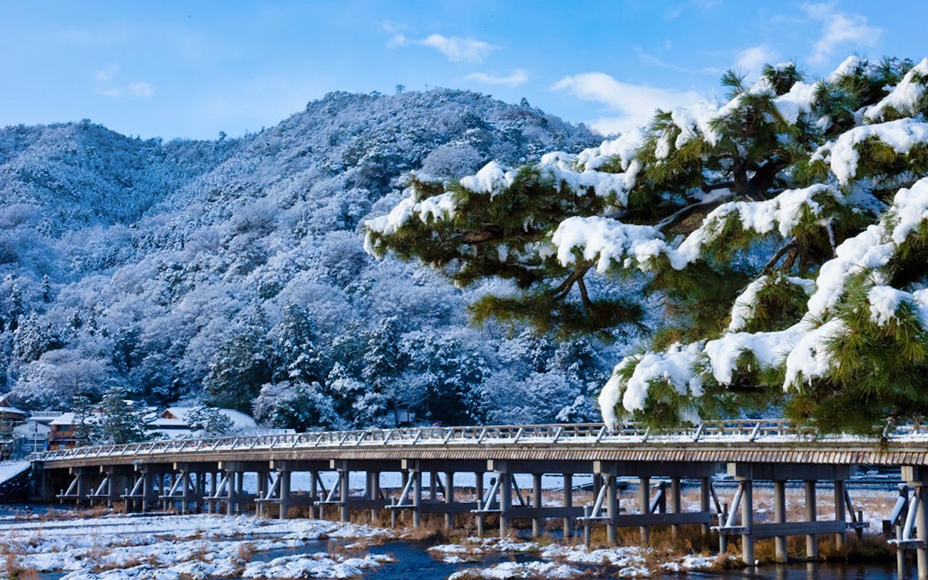 Togetsukyo Bridge in snowy Arashiyama, Kyoto, during a sightseeing tour.