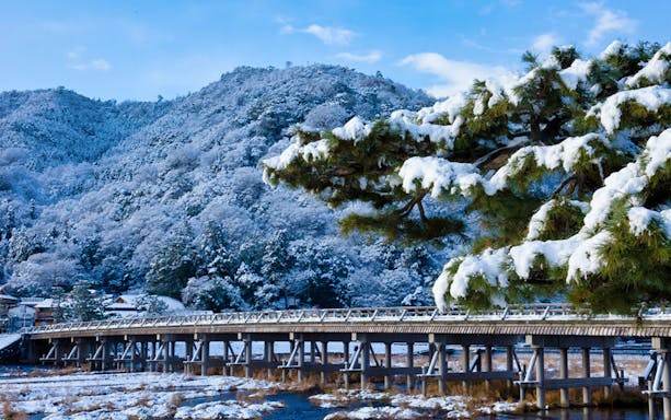 Togetsukyo Bridge in snowy Arashiyama, Kyoto, during a sightseeing tour.