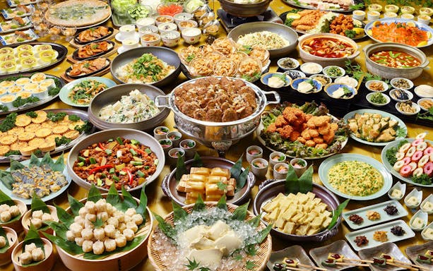 Assorted Japanese dishes on a buffet table during the Arashiyama Kinkakuji Nara Park Kobe Mosaic tour.