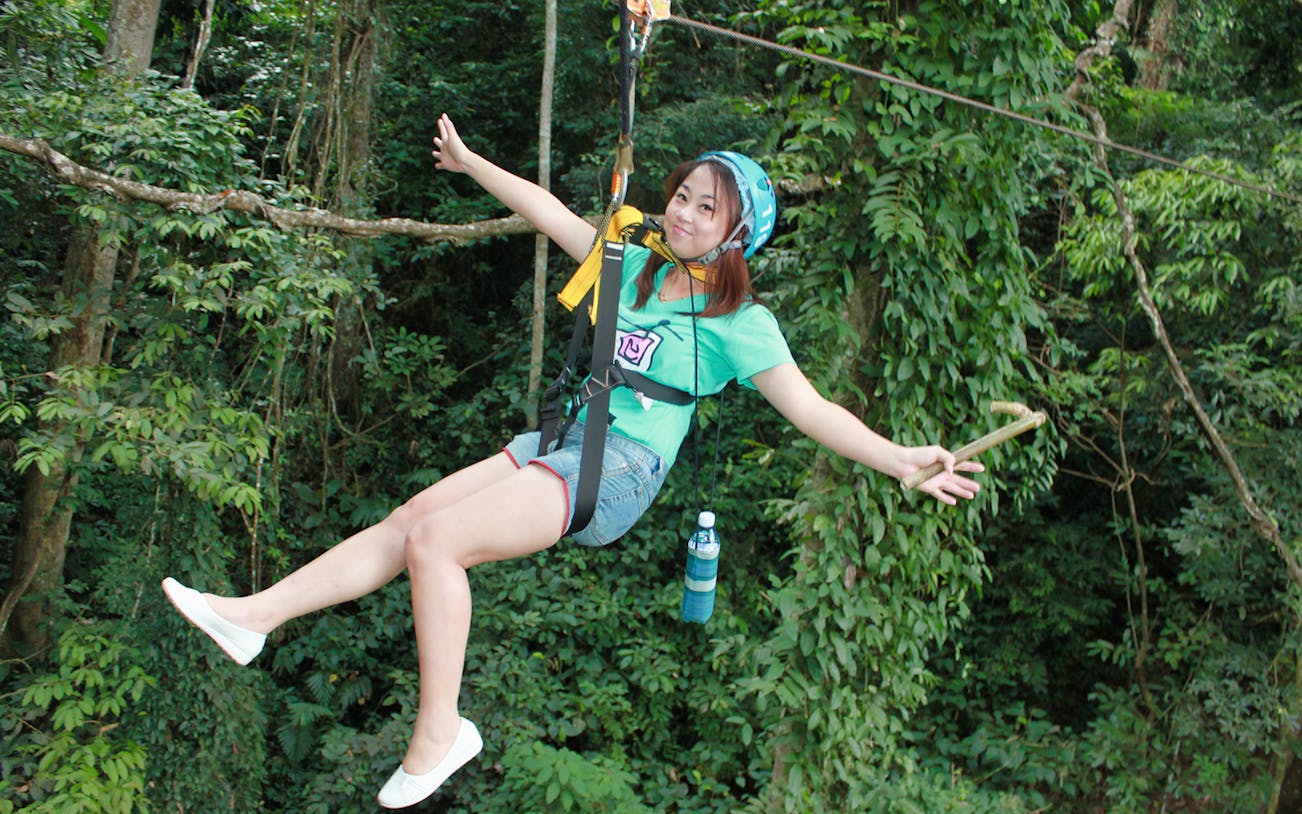 Ziplining through lush forest on Eagle Track Zipline Adventure.
