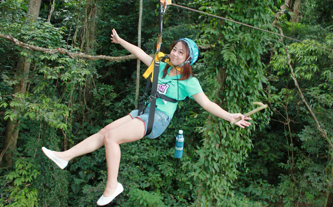 Ziplining through lush forest on Eagle Track Zipline Adventure.