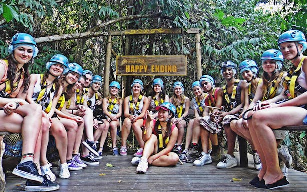 Group of people in helmets and harnesses at Eagle Track Zipline Adventure.