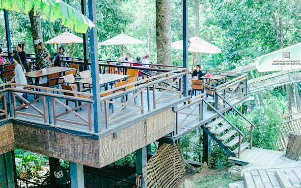 Outdoor dining area in a lush jungle setting, part of Jungle Flight Zipline Adventure.