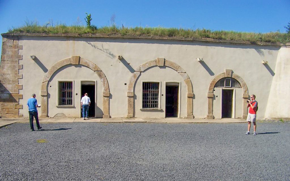Visitors exploring Terezin Concentration Camp building on a tour from Prague.