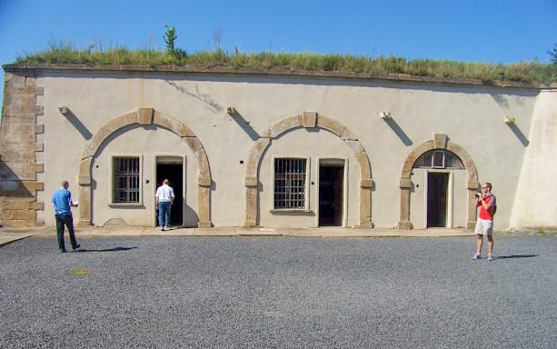 Visitors exploring Terezin Concentration Camp building on a tour from Prague.