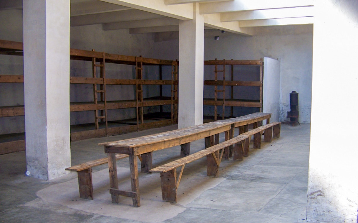 Wooden bunks and benches inside Terezin Concentration Camp barracks, Czech Republic.