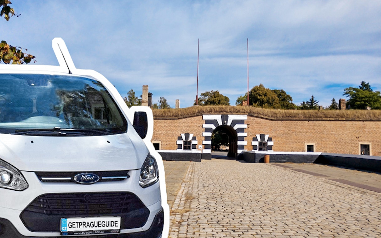 Terezin Concentration Camp entrance with tour van parked nearby, Czech Republic.
