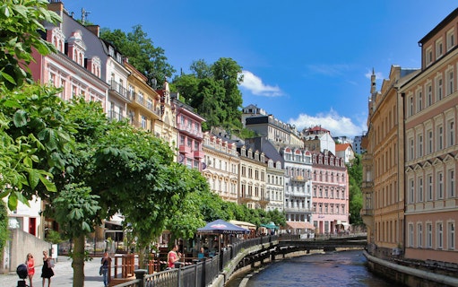 Colorful historic buildings along the river in Karlovy Vary, Czech Republic.