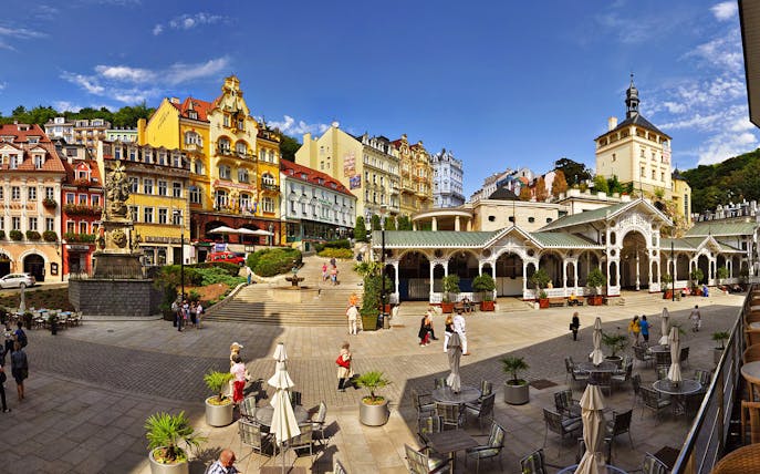 Colorful buildings and colonnade in Karlovy Vary town square, Czech Republic.
