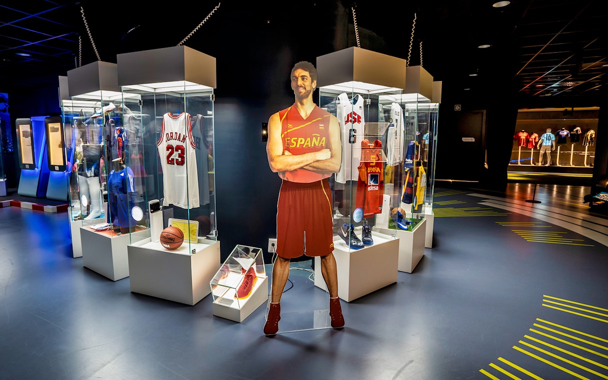 Sports memorabilia display at Rafa Nadal Museum Xperience, featuring jerseys and basketball items.