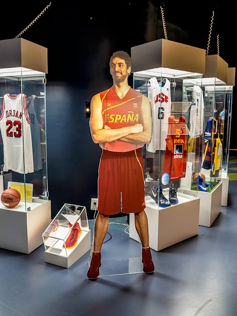 Sports memorabilia display at Rafa Nadal Museum Xperience, featuring jerseys and basketball items.