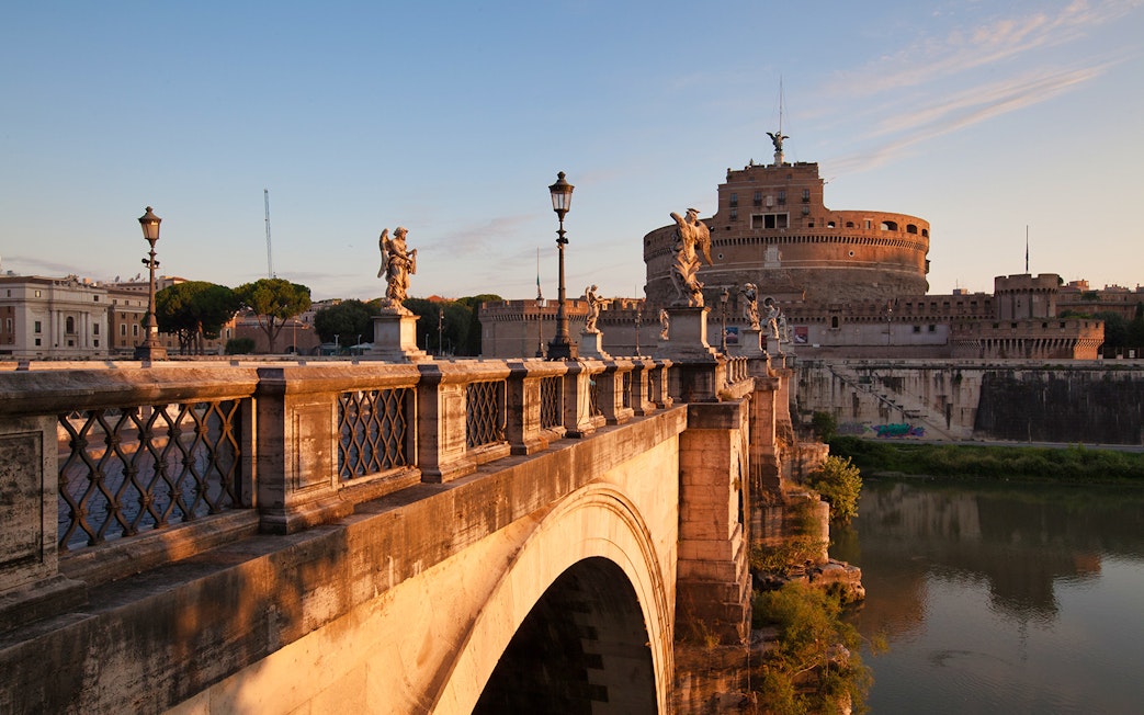 Bridge leading to Castel Sant'Angelo in Rome at sunset.