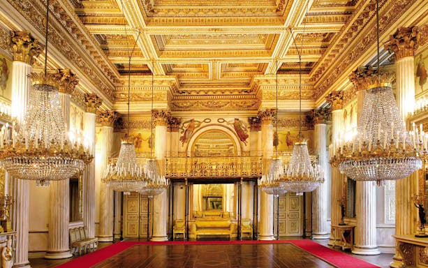 Royal Palace Museum grand hall with chandeliers and ornate ceiling.