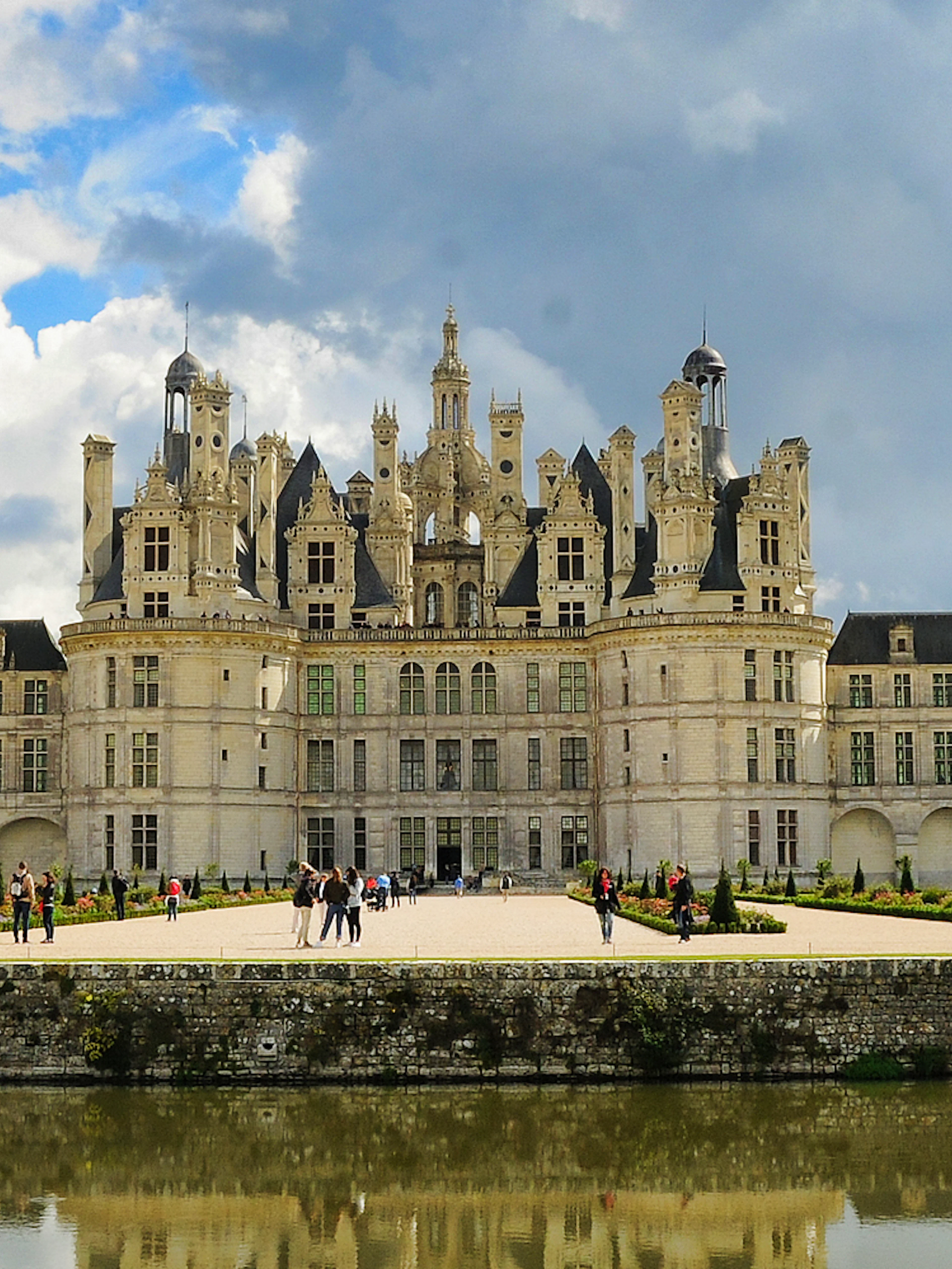 Château de Chambord with visitors in the garden, Loire Valley, France.