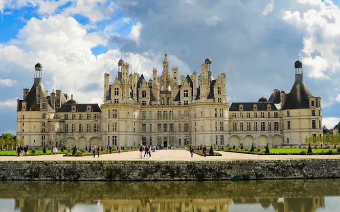 Château de Chambord with visitors in the garden, Loire Valley, France.