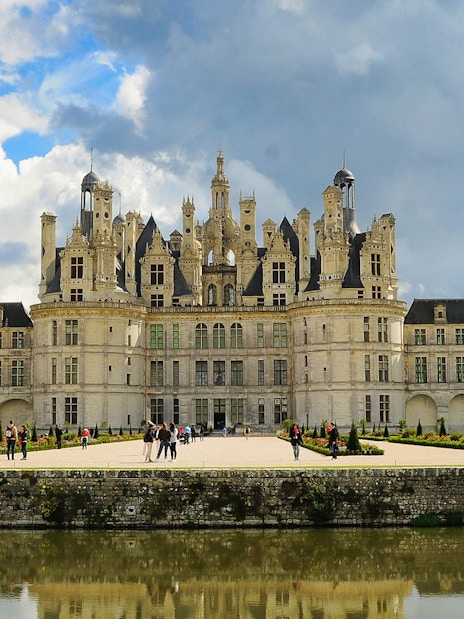 Château de Chambord with visitors in the garden, Loire Valley, France.