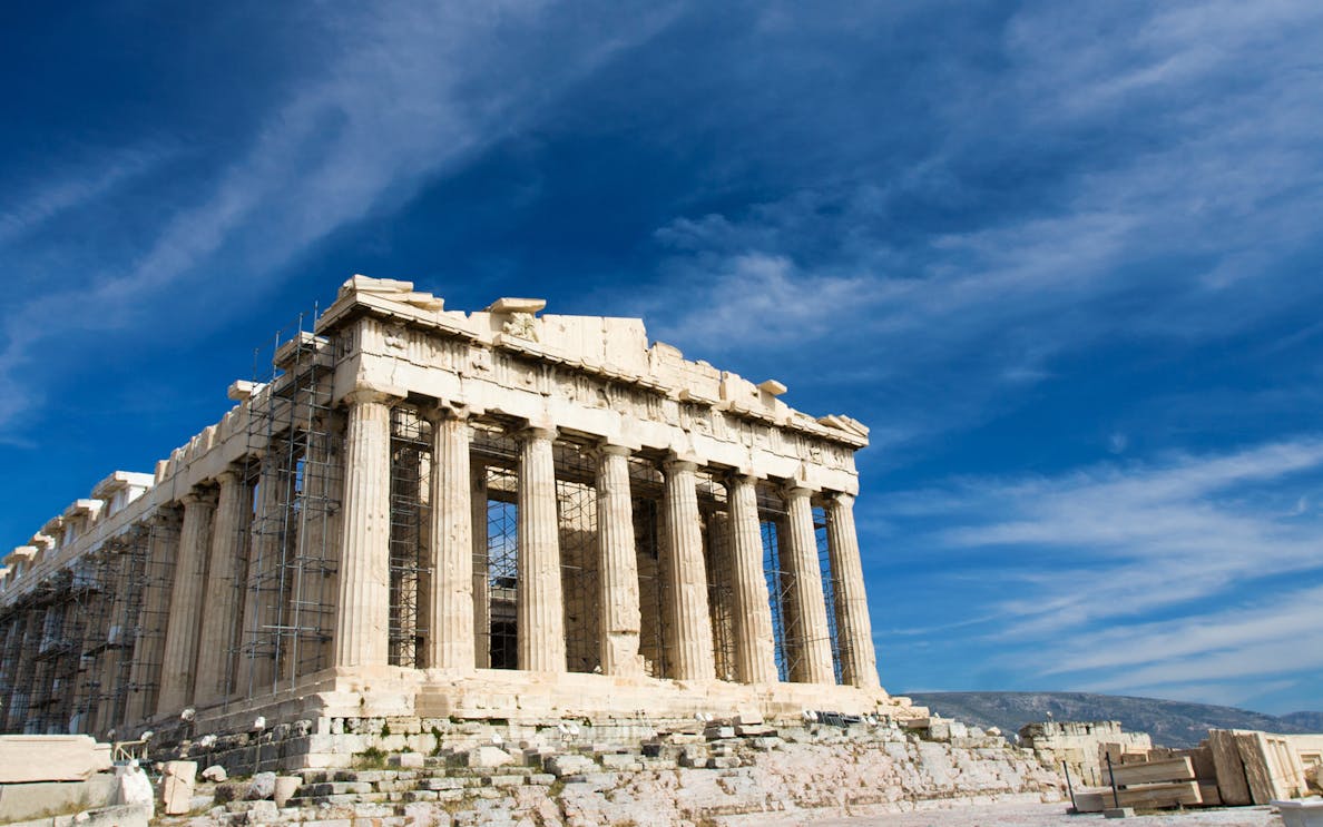 Parthenon on the Acropolis in Athens under a clear blue sky.