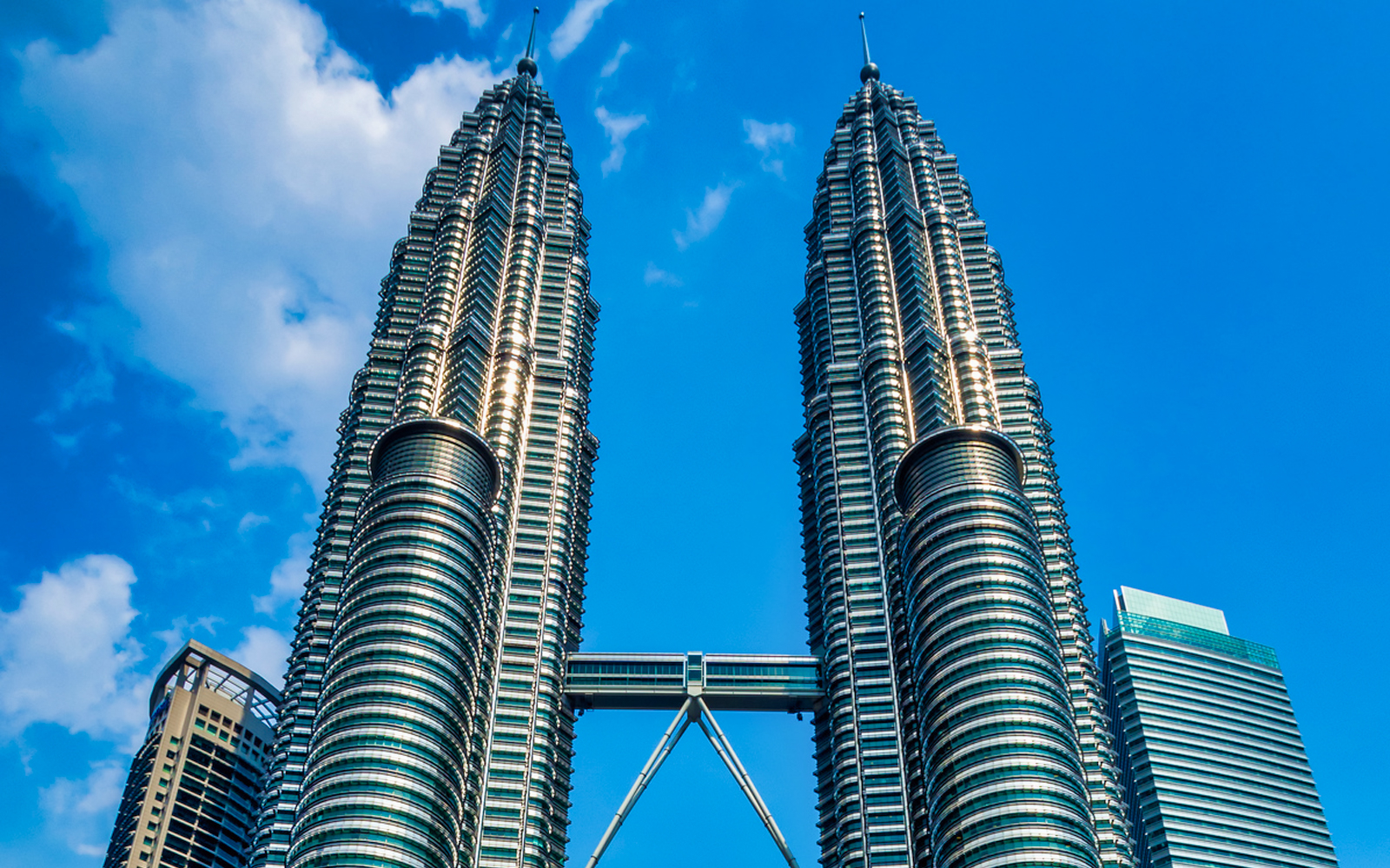 Petronas Twin Towers in Kuala Lumpur against a blue sky.