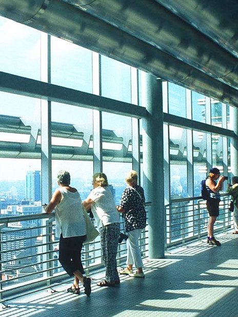 Visitors on the Petronas Twin Towers skybridge, Kuala Lumpur, enjoying city views.