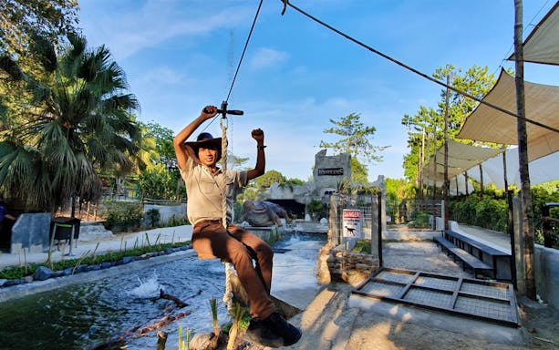 Man ziplining over crocodile enclosure at Crocodile Adventureland Langkawi.