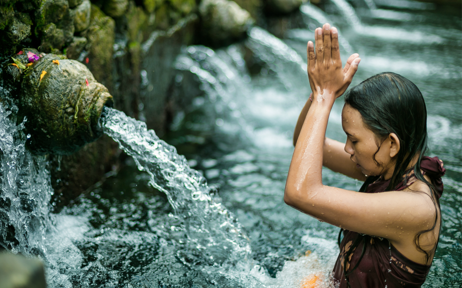 Person participating in a purification ritual at Ubud's sacred water temple.