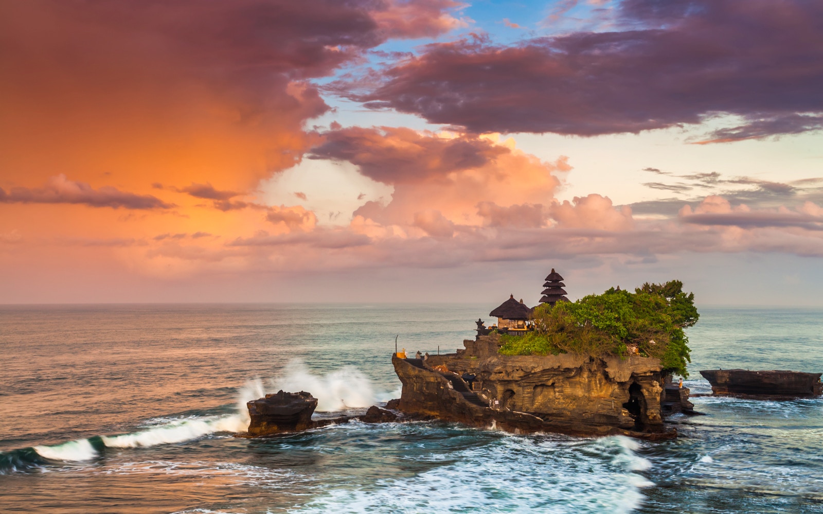 Tanah Lot Temple on a rocky outcrop at sunset, Bali, Indonesia.
