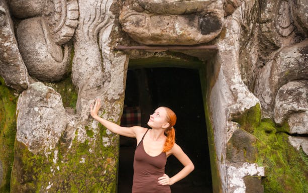 Visitor at Goa Gajah Temple entrance, Kintamani Small Group Tour.