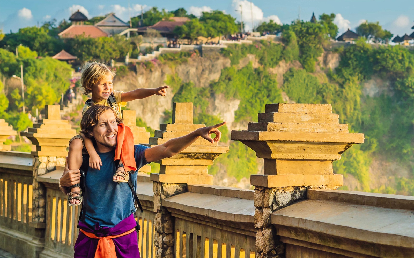 Father and child enjoying the view at Uluwatu Temple, South Bali.