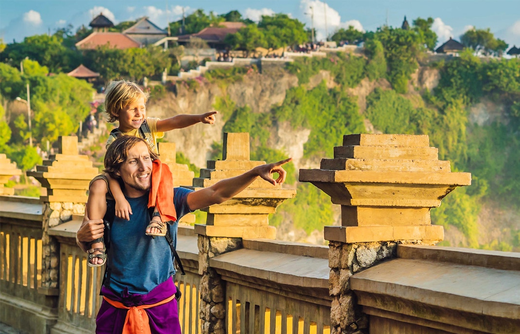 Father and child enjoying the view at Uluwatu Temple, South Bali.
