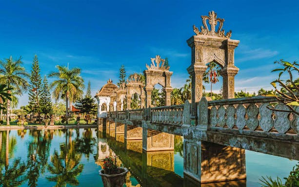 Stone bridge and ornate arches at Taman Ujung Water Palace, East Bali.