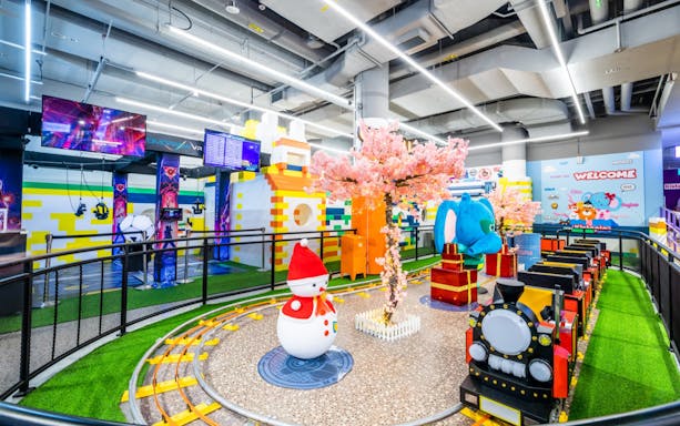 Indoor playground at Kiztopia Marina Square with train ride and colorful decorations.