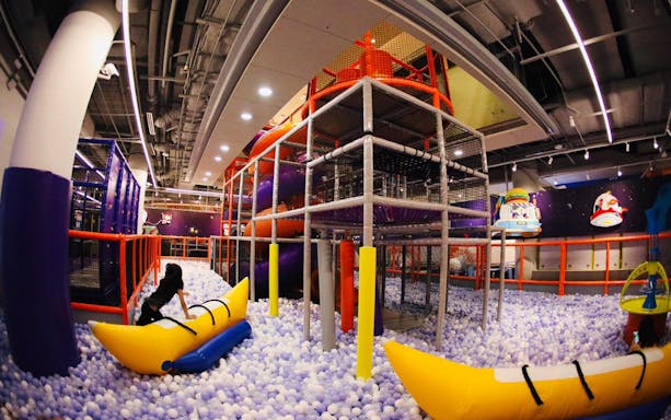 Indoor playground with climbing structures and ball pit at Kiztopia Marina Square.