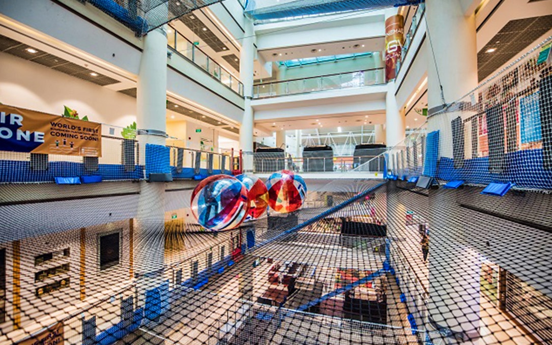 Suspended net playground with colorful spheres at Air Zone Singapore indoor attraction.