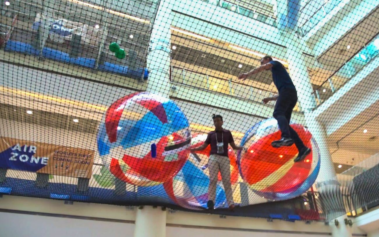 Participants enjoying giant ball activities at Air Zone Singapore indoor playground.