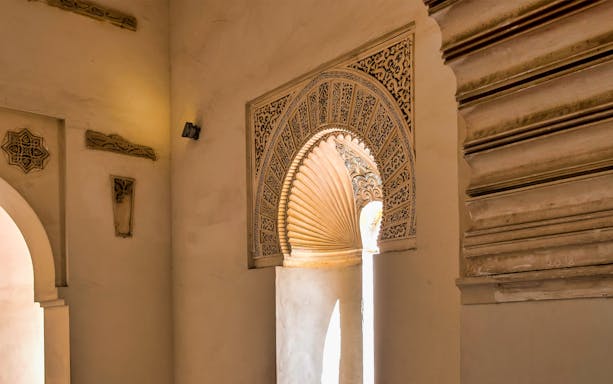 Intricate Moorish arch detail in Malaga's historic site, part of walking tour with skip-the-line access.