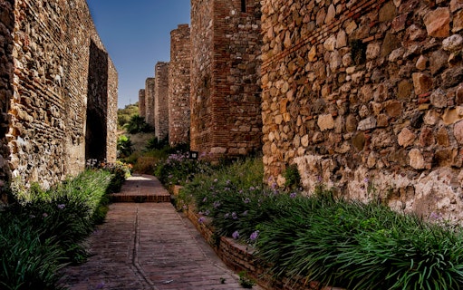 Ancient stone walls and pathway in Alcazaba, Malaga, Spain, part of walking tour.