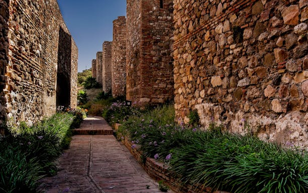 Ancient stone walls and pathway in Alcazaba, Malaga, Spain, part of walking tour.