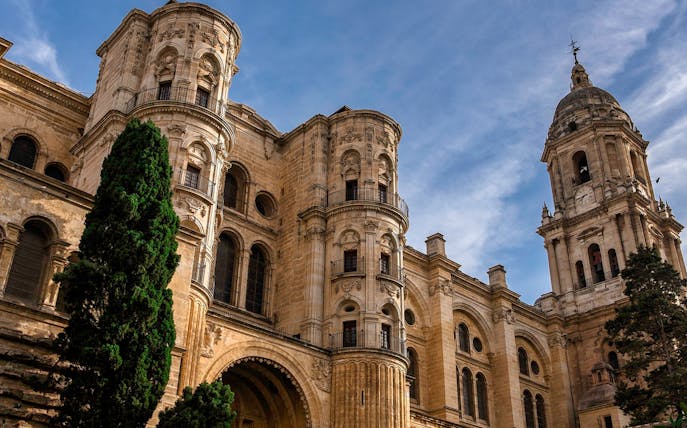 Malaga Cathedral exterior on a sunny day during a walking tour.