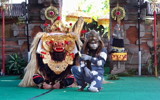 Balinese Barong and monkey performers in traditional costumes during Ubud Bali tour.