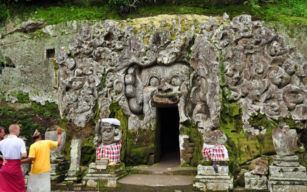 Goa Gajah temple entrance with intricate stone carvings, Bali.
