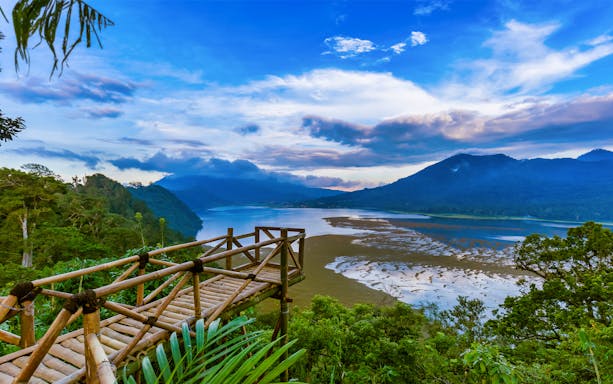 Bali Twin Lakes view from bamboo platform with lush greenery and mountains in the background.