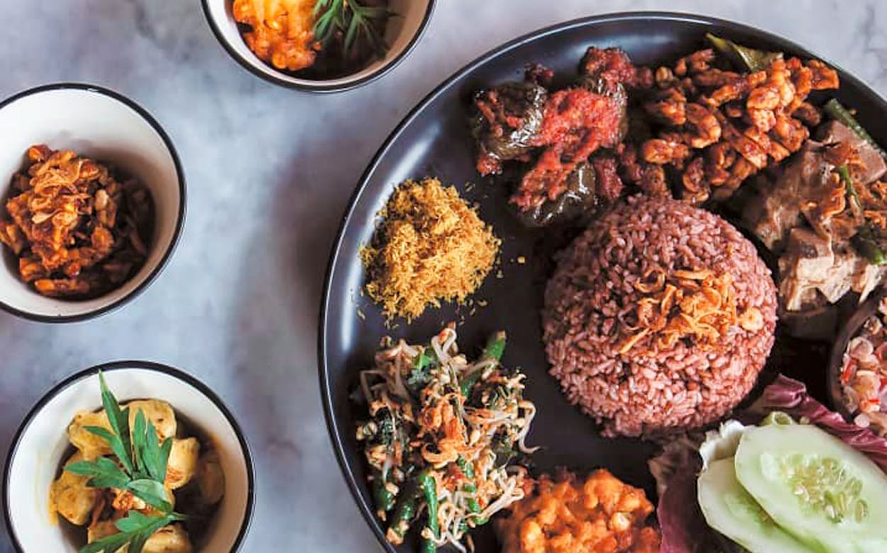 Balinese dishes with rice and vegetables from a cooking class in Bali.