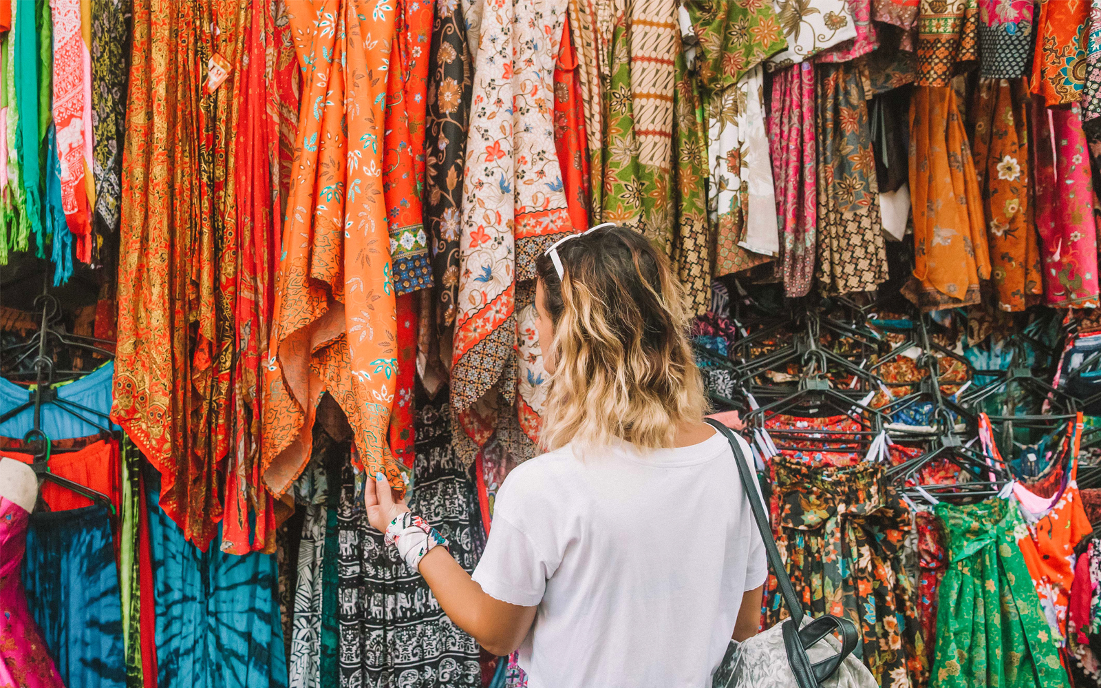 Ubud Market stalls with colorful textiles and crafts, part of Ubud Private Tour in Bali.